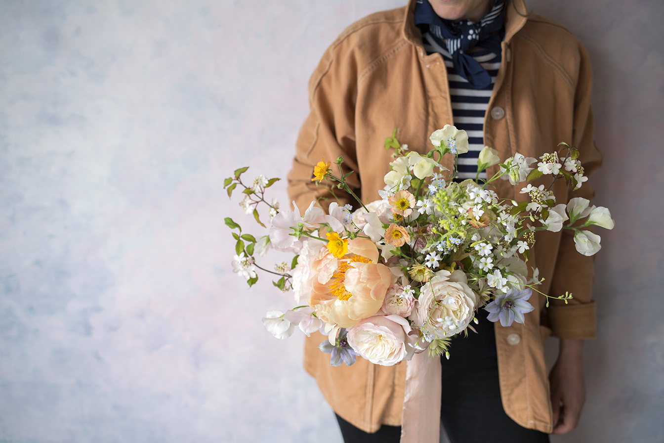 A sugary palette of cream, blush, peach and pale blue - the first garden roses, viburnum, geum and clematis.