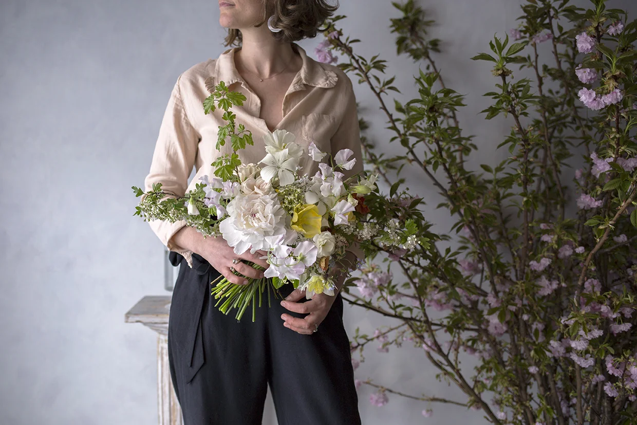 Jess's demo bridal bouquet - hawthorn branches for structure, a focal creamy peony, lemon-yellow tulips, white agrostemma and sudsy sweet peas.