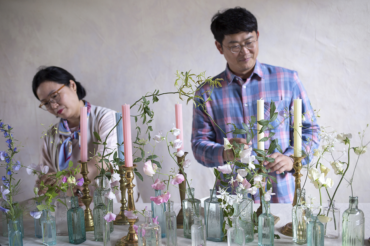 Table styling; using small vessels of individual stems to create an impactful seasonal tablescape. Mr Ha, perfectly colour coordinating in his beautiful shirt!