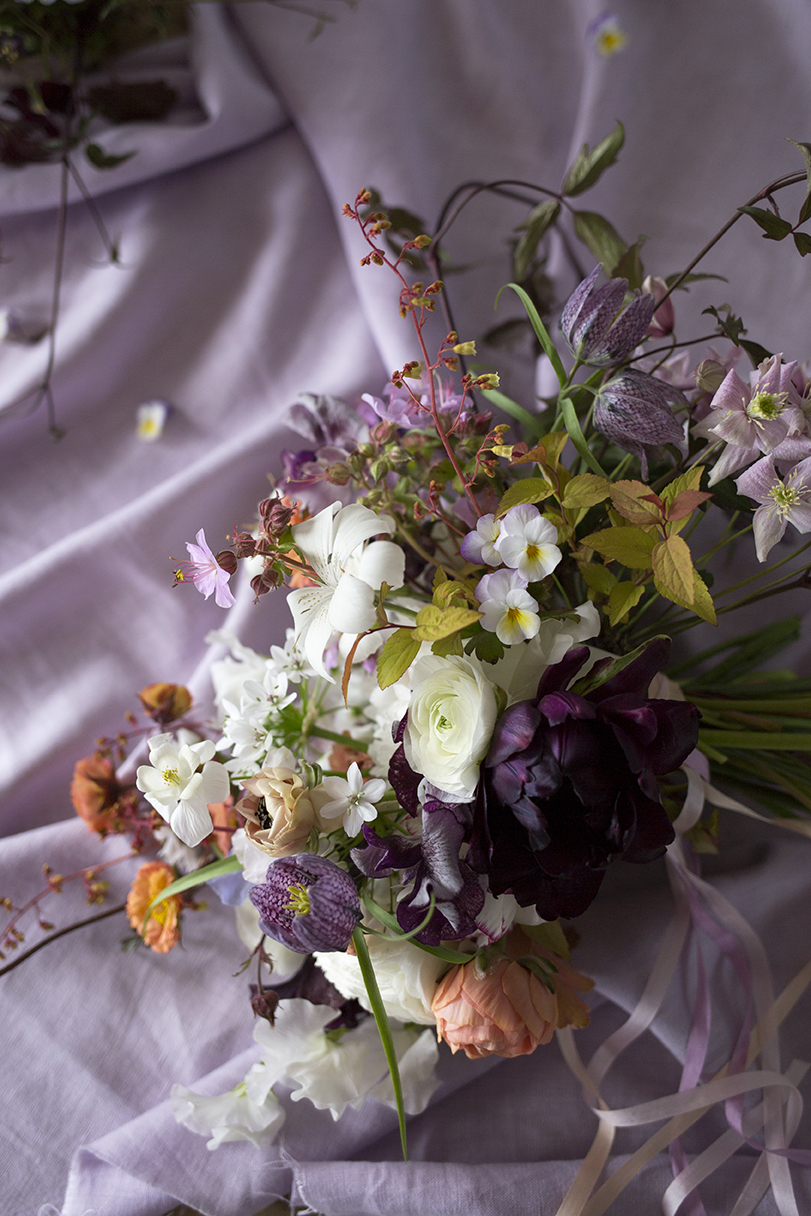 A spring wedding bouquet with pansies made by a student at a private class at Aesme Flower Studio