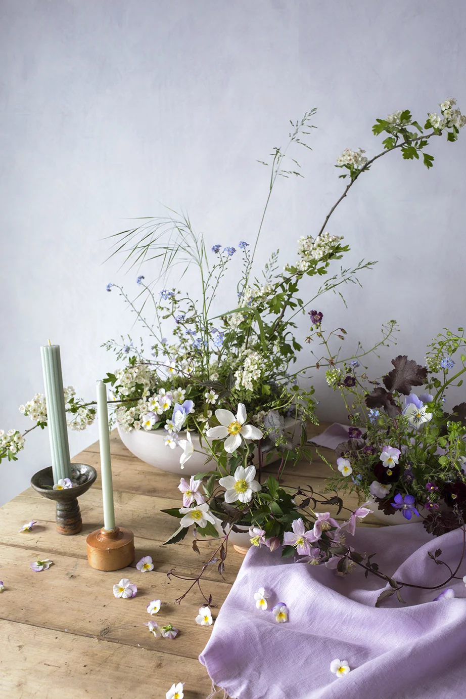 Palette | Ice white, lavender, amethyst, plum Materials| Pansy, clematis, forget-me-not, hawthorn, anemone Vessels | Ceramic bowls (mixed sizes)