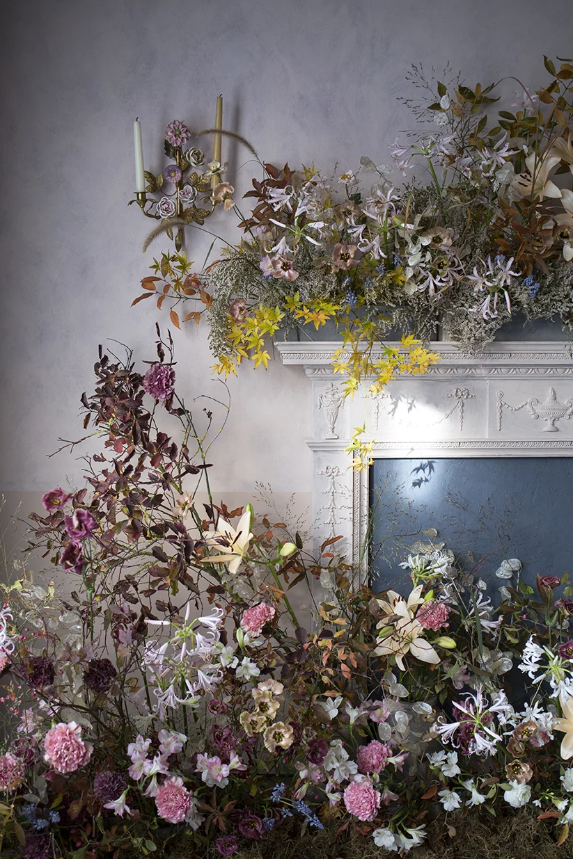 A mantelpiece installation of autumnal flowers and foliage made during a group workshop at Aesme Flower Studio