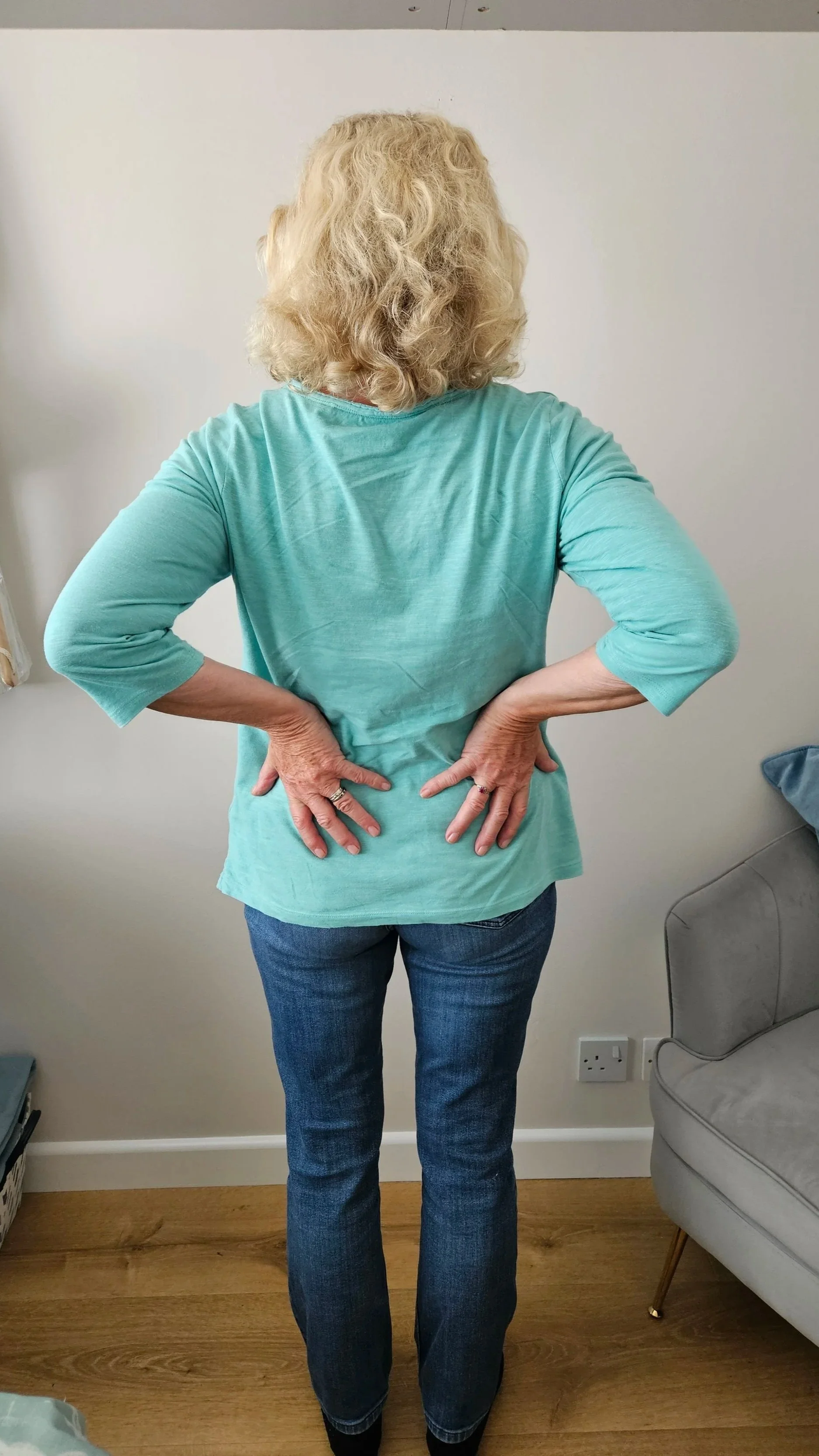 Image of woman with back pain in the treatment room of Liz Guthrie Therapies, Sandhurst, Berkshire