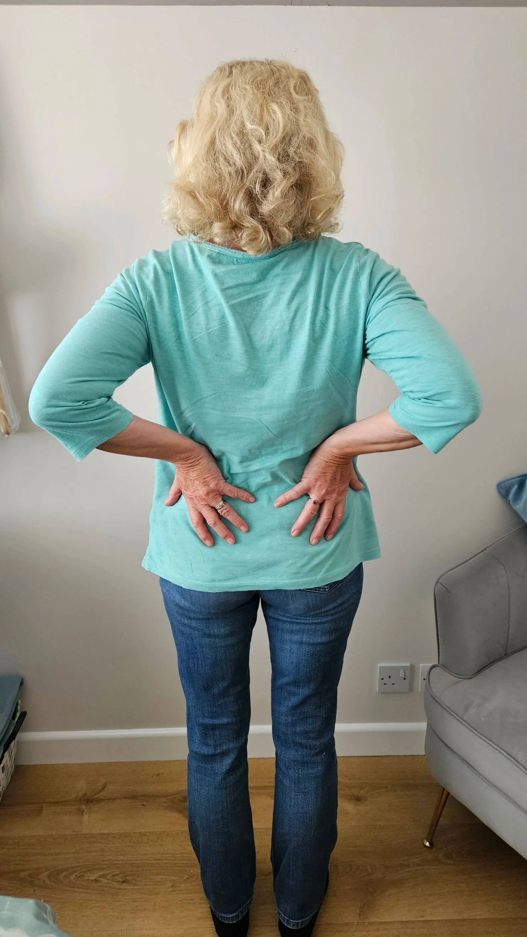 Women with blond hair showing back pain