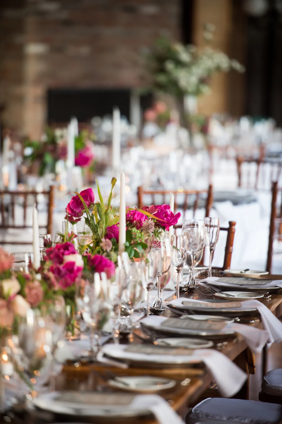liberty-warehouse-wedding-long-wood-tables-magenta-centerpieces