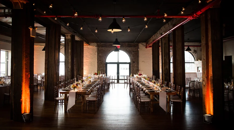 liberty-warehouse-wedding-pegasus-lighting-edison-bulbs-bistro-string-lights-long-wood-tables