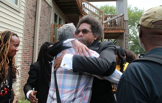 Palestinian father Siam Nowara embraces public intellectual Cornel West following a commemoration event on the year anniversary and at the site where 18-year old Michael Brown Jr. was killed by police. (Photo taken by Carlton Mackey)