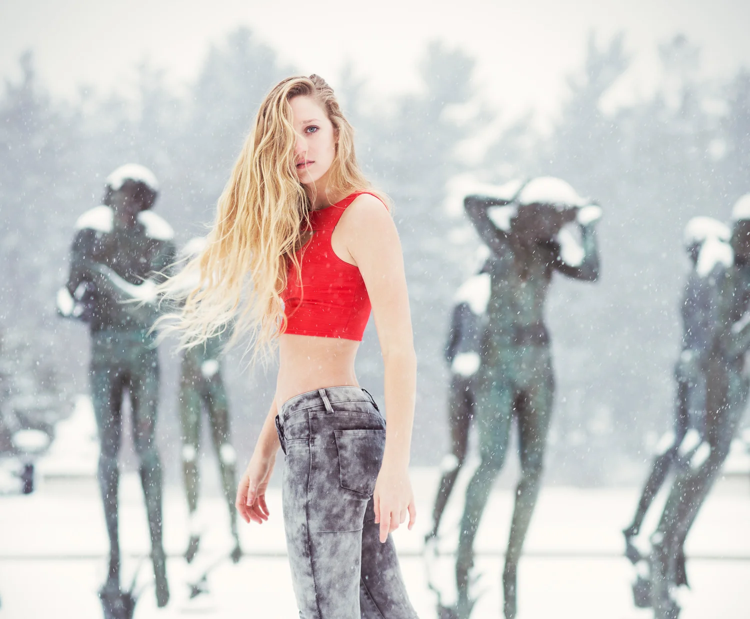 Model posing in red top at Cranbrook Academy of Art during a snowstorm