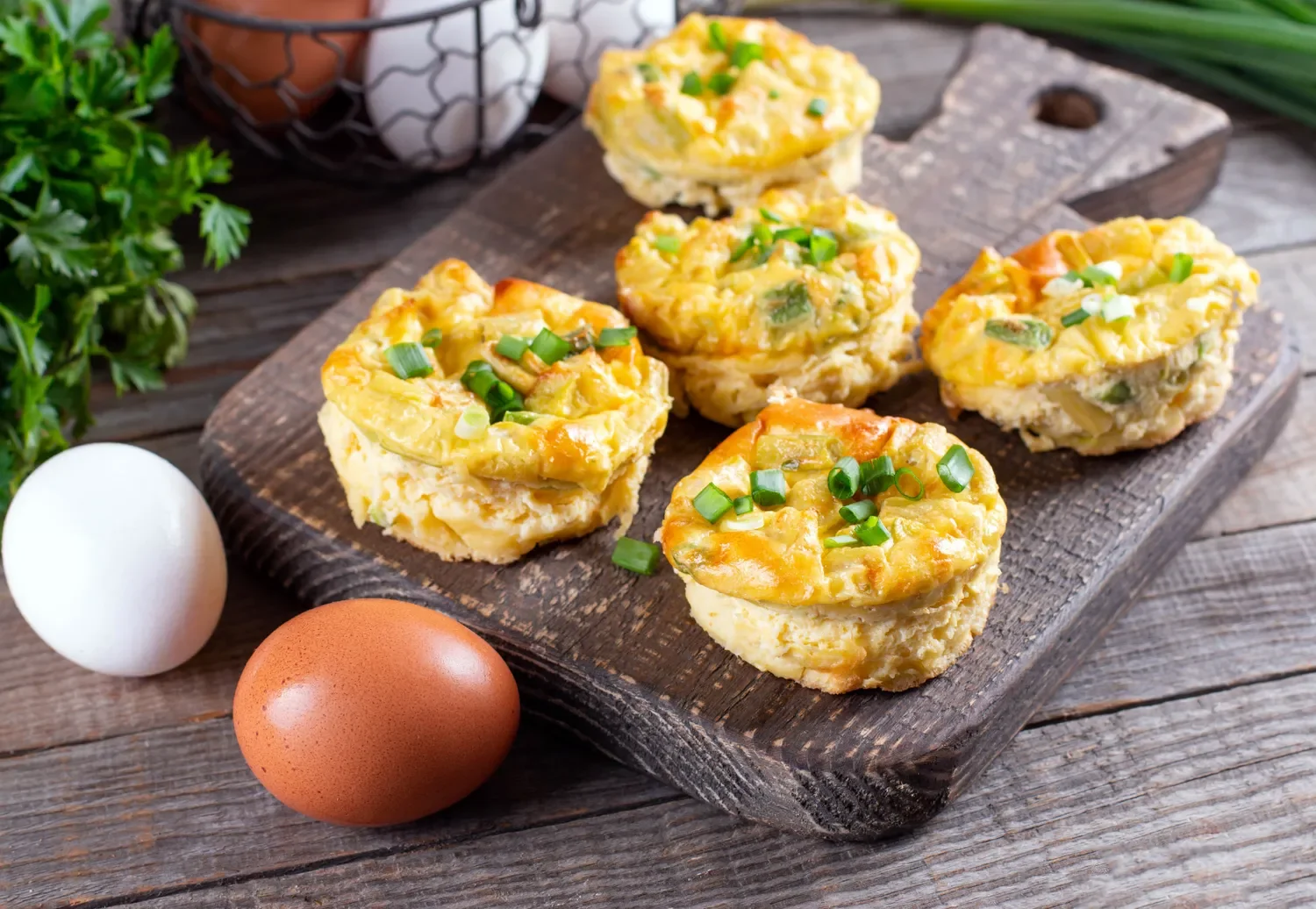 several egg tarts on a wood serving block