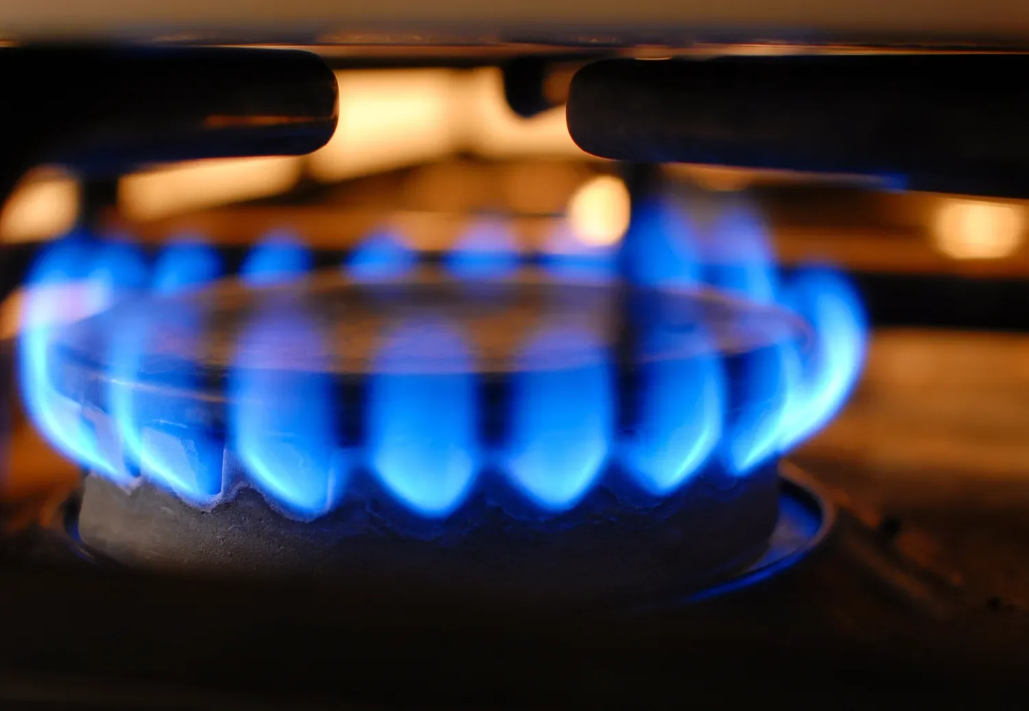 image of a gas stove burner up close with flame on.