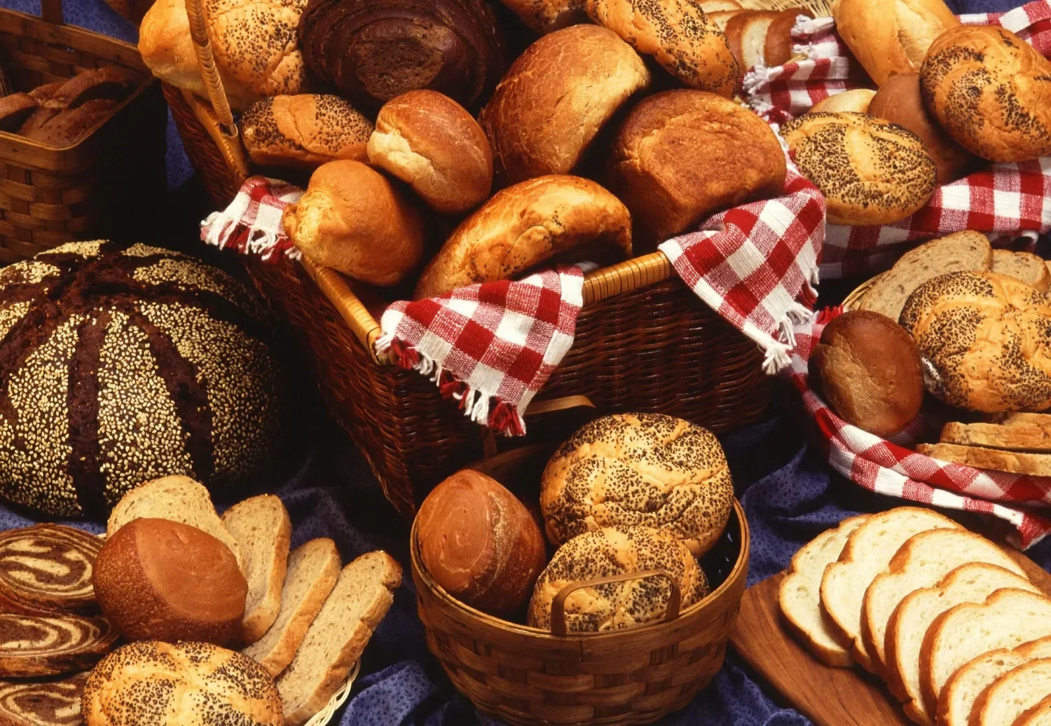 various types of bread on display in baskets