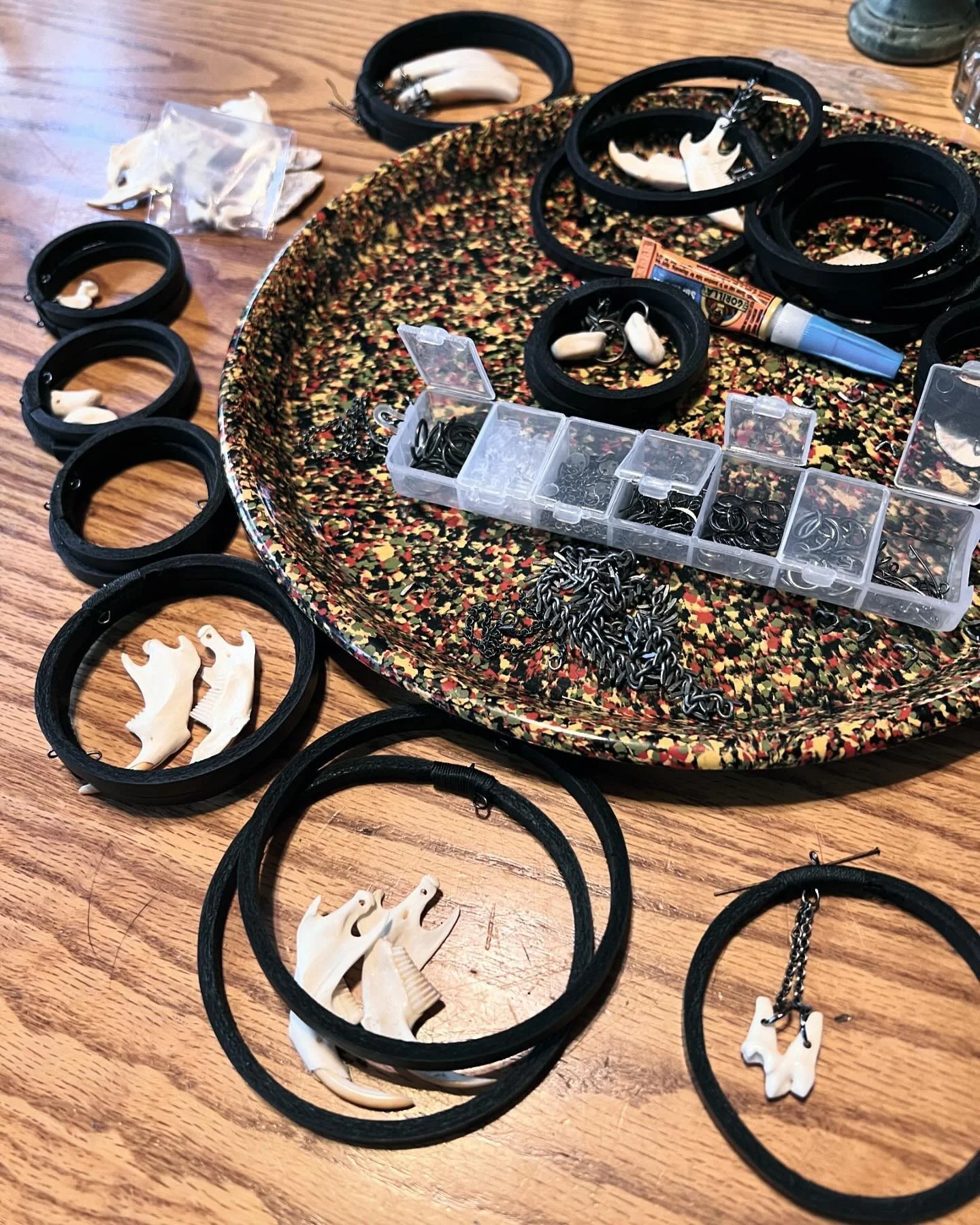 In process shot of a bunch of bone hoops that I dropped off at @twelve_vultures yesterday! Molded leather hoops with dangling bones in the middle. Bone options include: muskrat jaws, bison teeth, coyote teeth, and deer ankle bones. 🖤☠️🖤