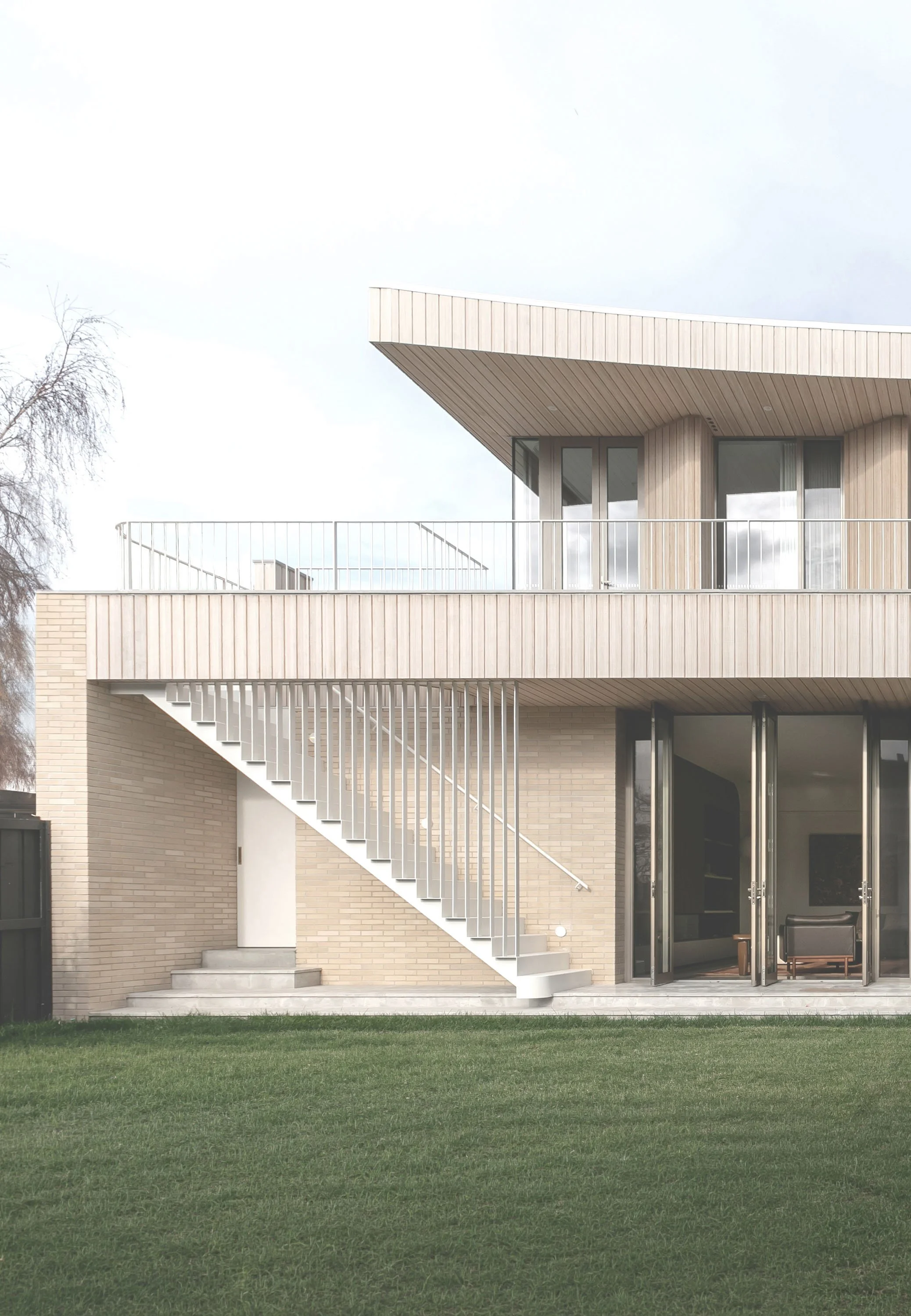 timber clad house with steel stair case