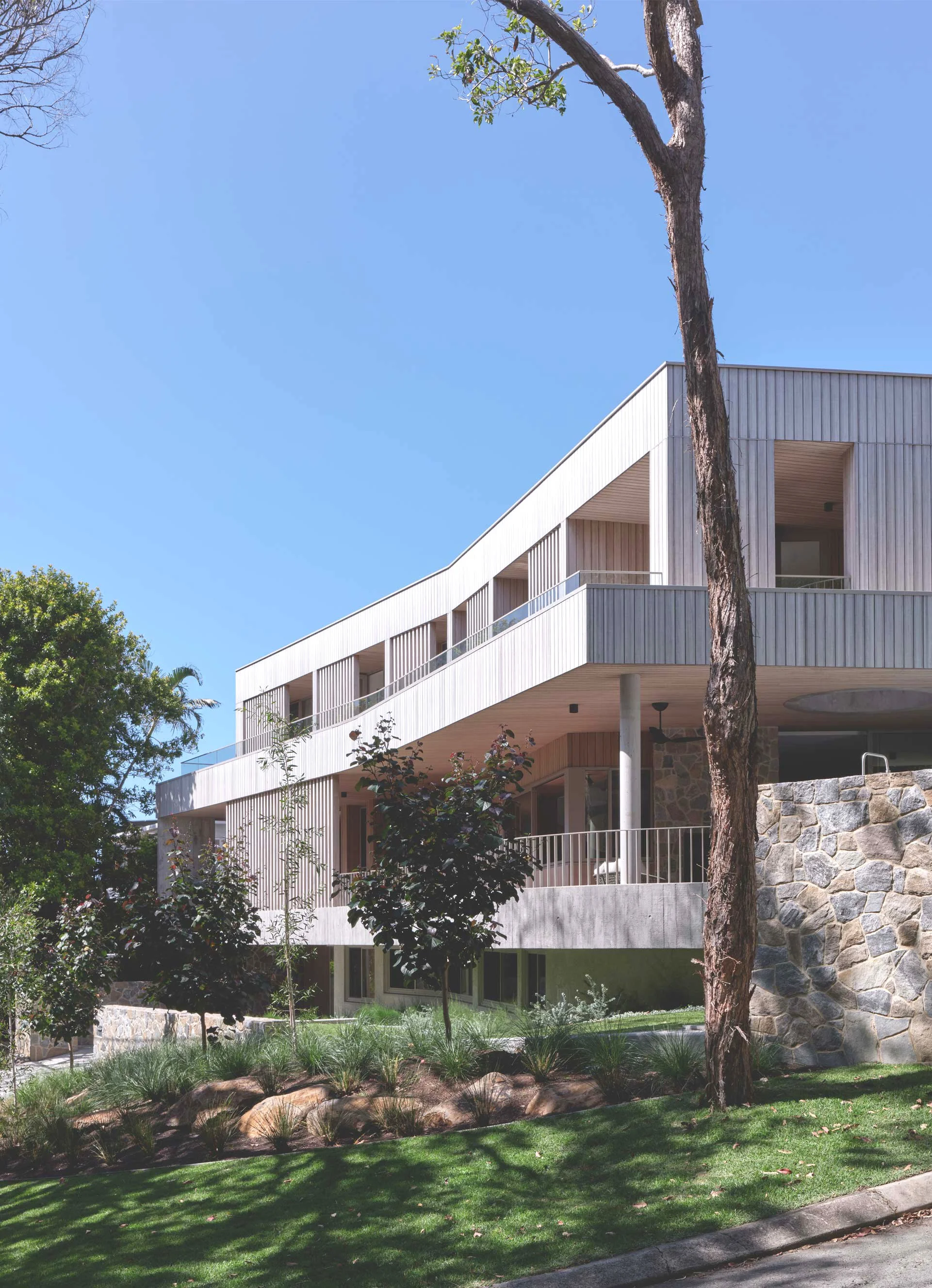 timber clad house in a coastal hillside setting