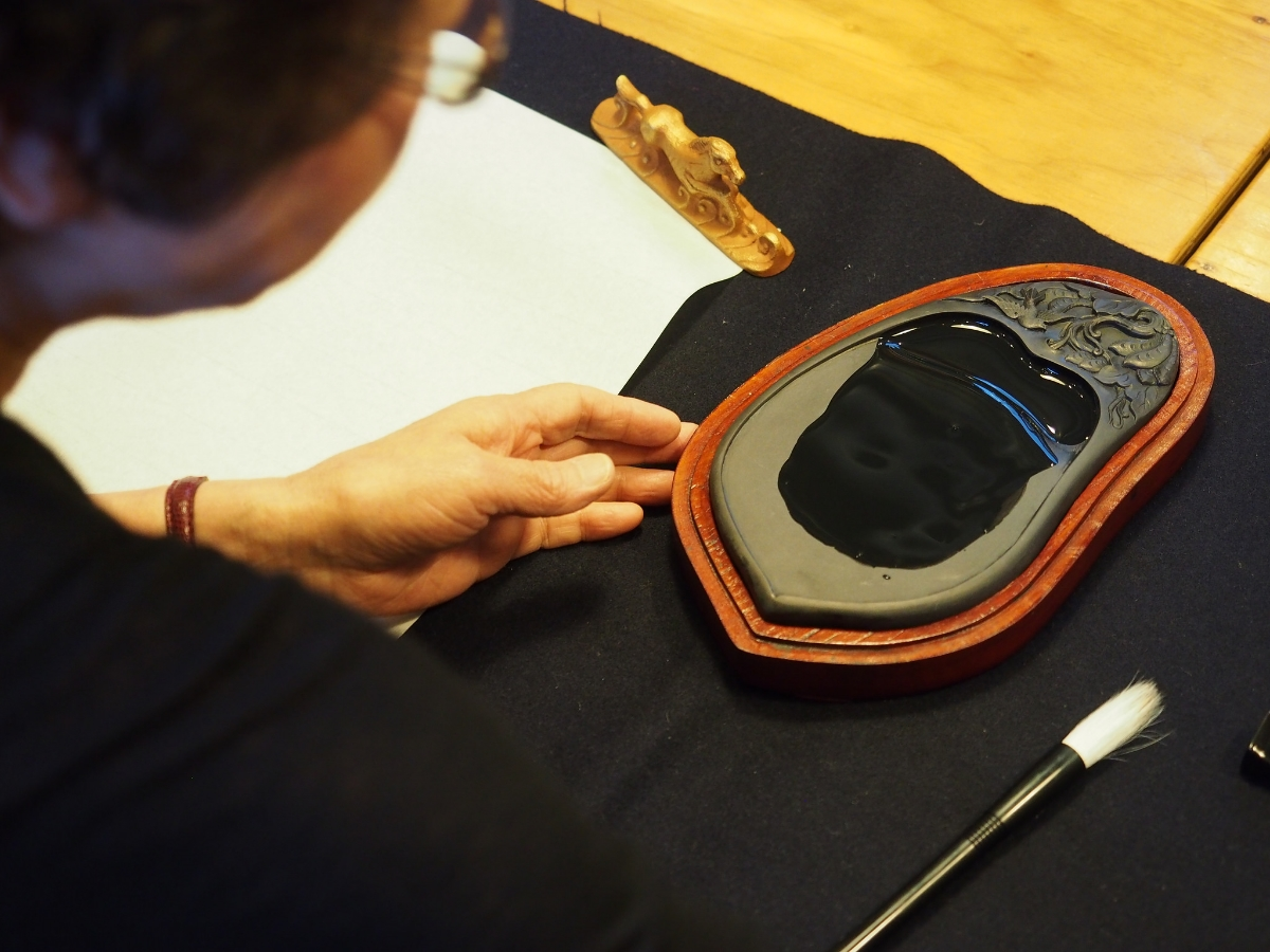 Charcoal ink is prepared in a basin known as a suzuri (硯). ©TOKI