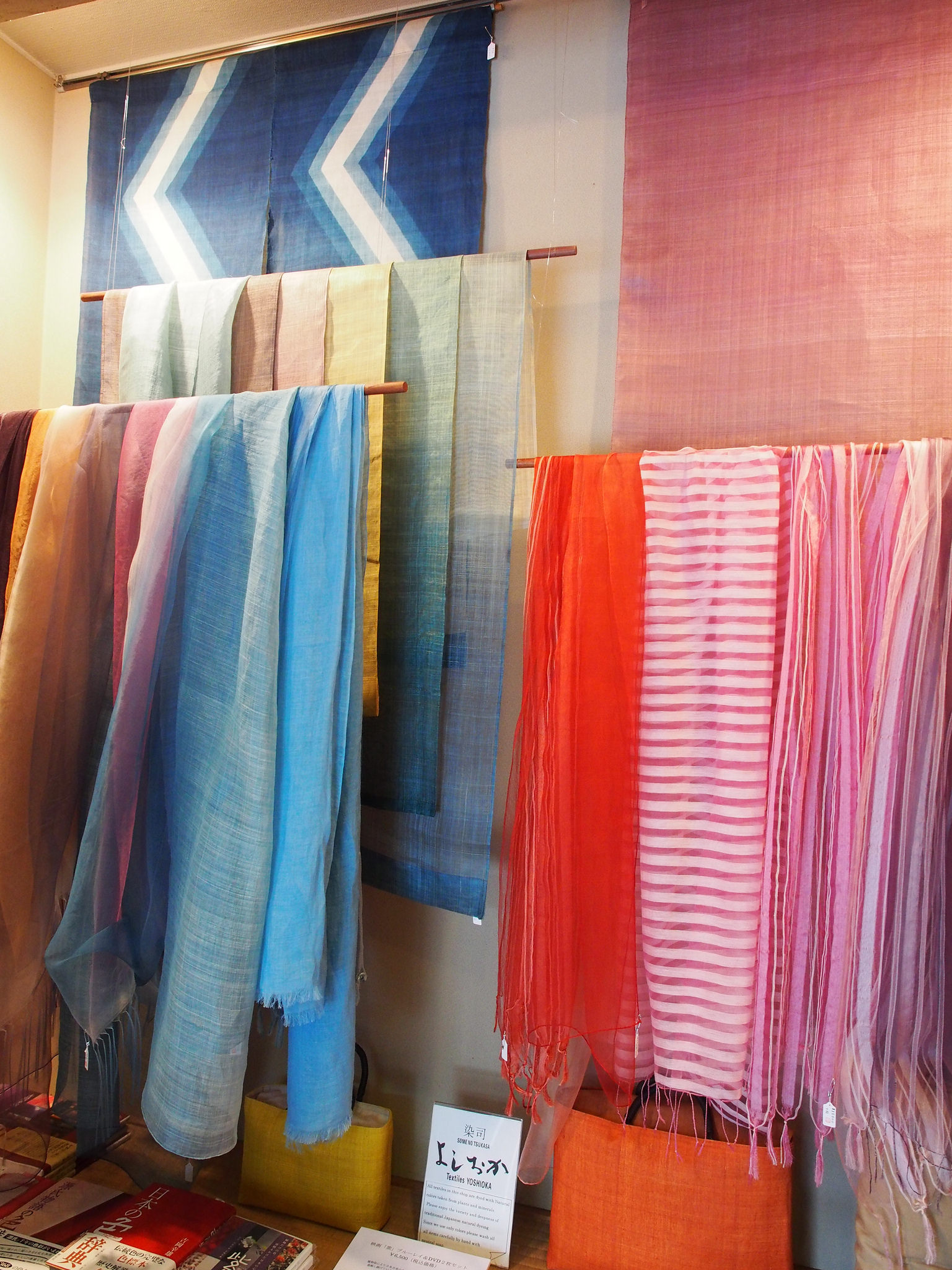 Some of the finished products that Yoshioka has created using his dyes. He makes a variety of unique, modern items (such as scarves and bags) as well as traditional textiles that are used in temples and shrines. ©TOKI