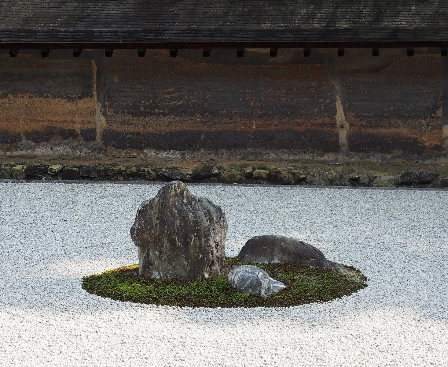 Zen temples and gardens often feature rustic, earthy color palettes - a characteristic of wabi-sabi. The wall behind Kyoto's Ryoanji's famous rock garden is a prime example of this. ©TOKI