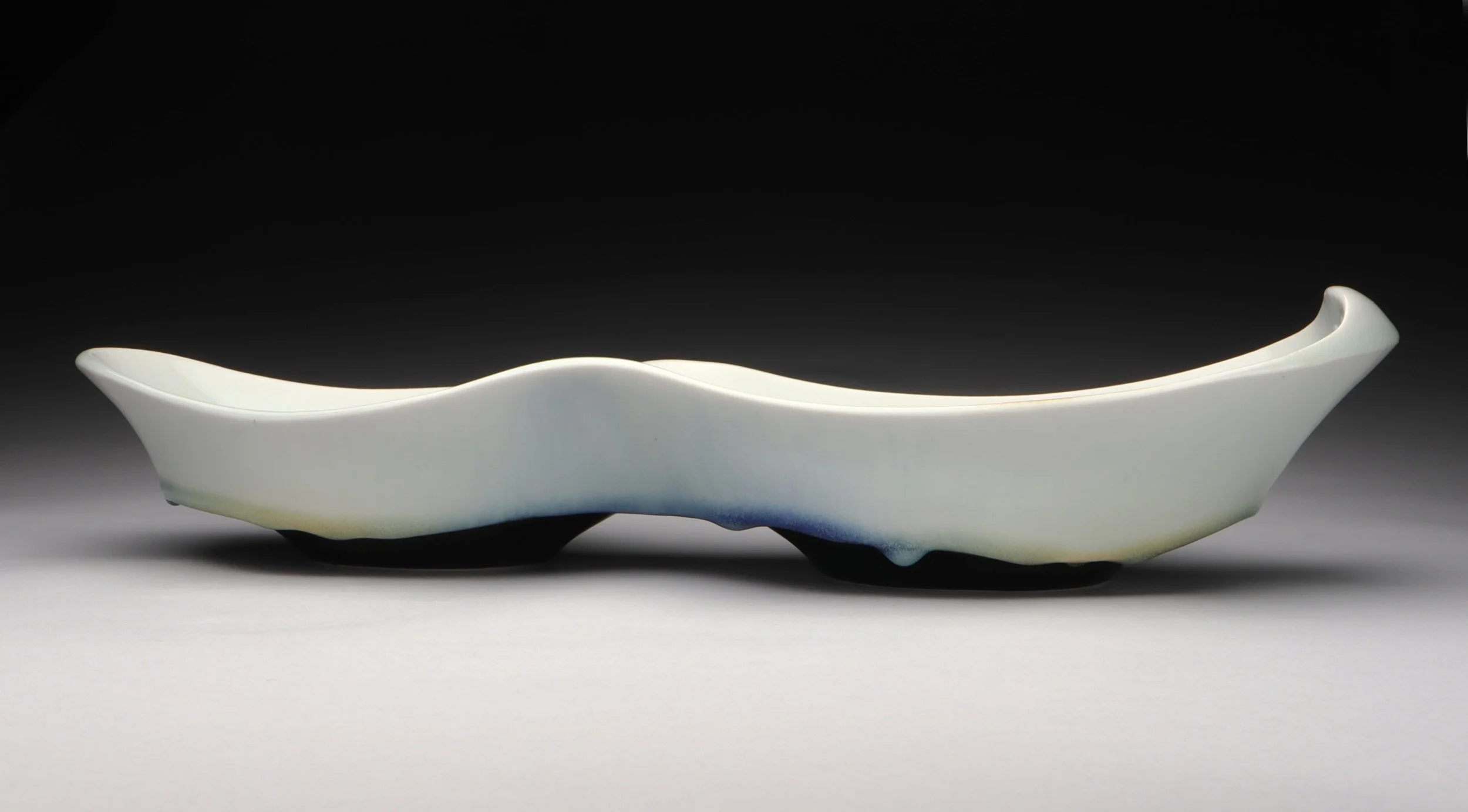 A white double pool tray with hints of blue and green at the bottom.