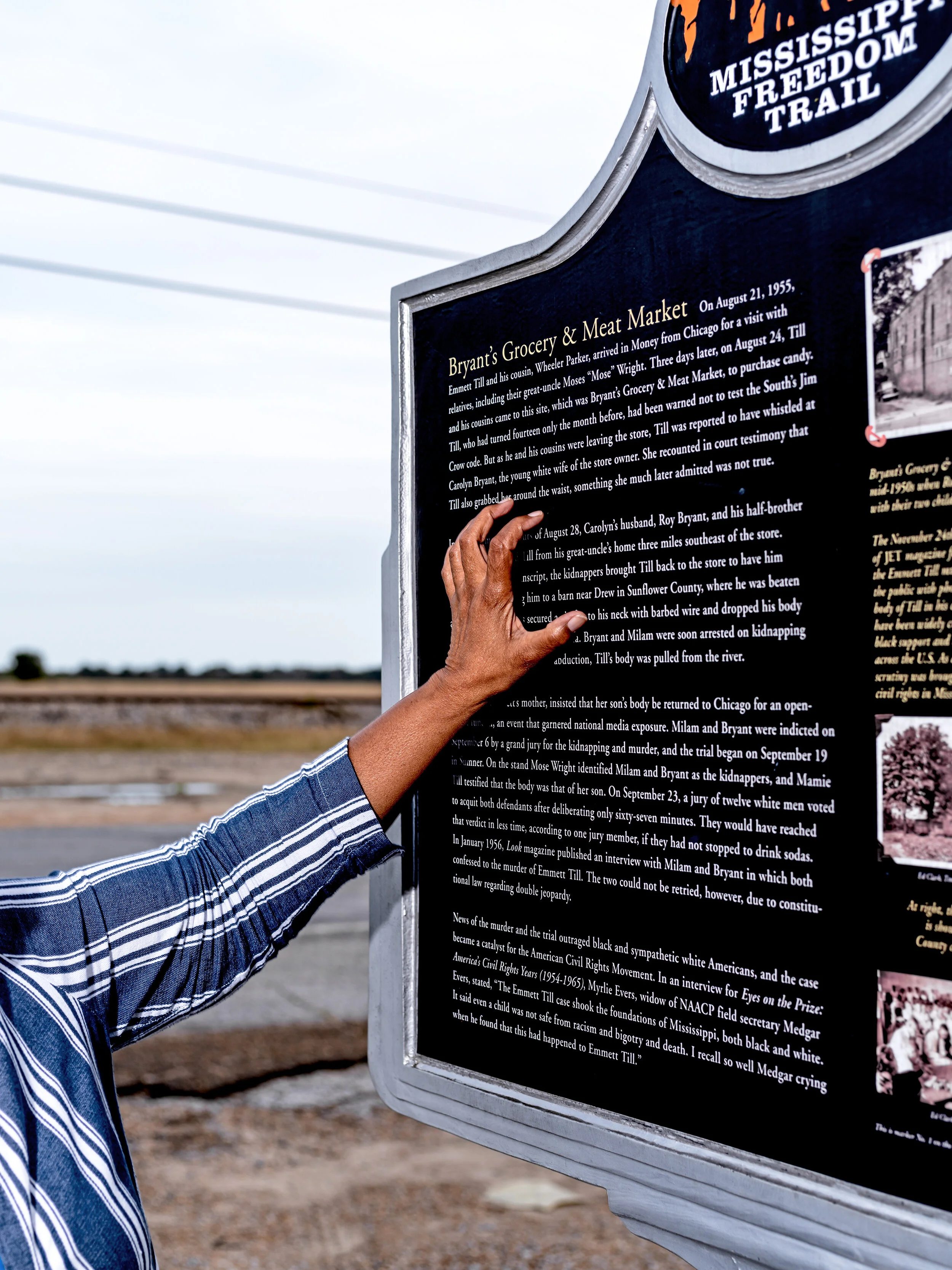  Jessie Jaynes-Diming of the E.T.M.C.  runs her hand down a commemorative marker placed outside of the former Bryant’s Grocery &amp; Meat Market. 
