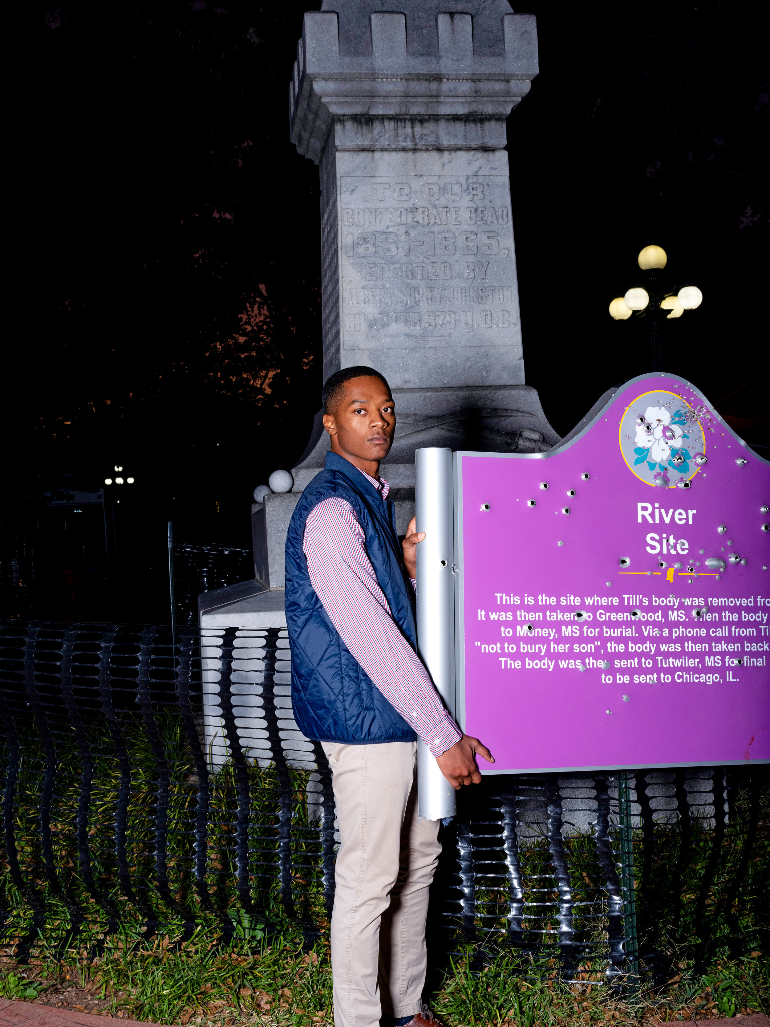 Ole Miss student Tyler Yarbrough holds a bullet ridden Emmett Till commemorative marker in front of a Confederate statue on campus.  