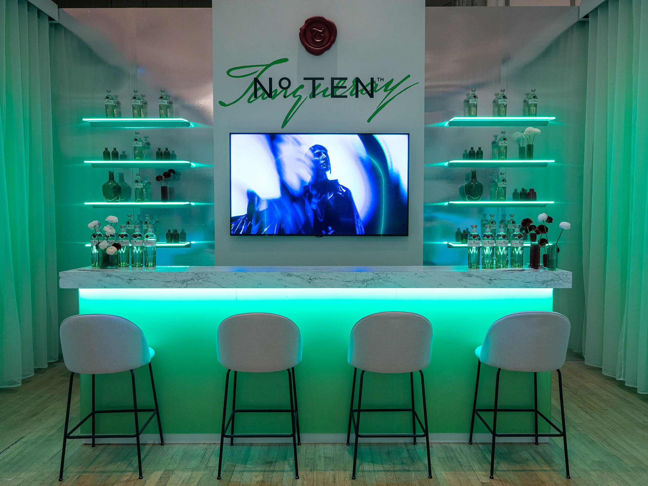 Custom Tanqueray bar fabricated by McWood for World Class 2025, featuring illuminated branding, premium finishes, custom millwork, and integrated event graphics at Toronto's Fairmont Royal York Hotel.