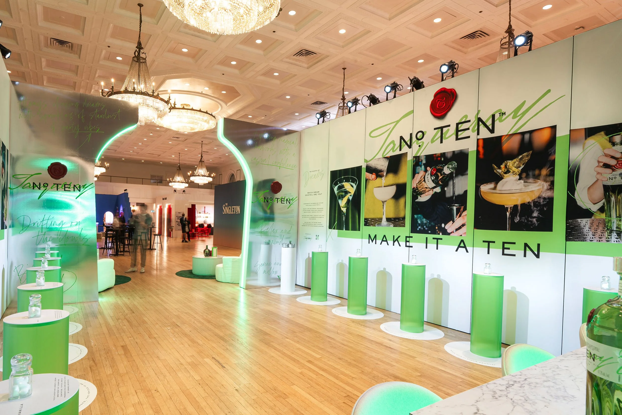 Interior of the Tanqueray branded environment fabricated by McWood for World Class 2025, featuring custom wall systems, illuminated signage, premium display elements, and immersive hospitality branding at Toronto's Fairmont Royal York Hotel.