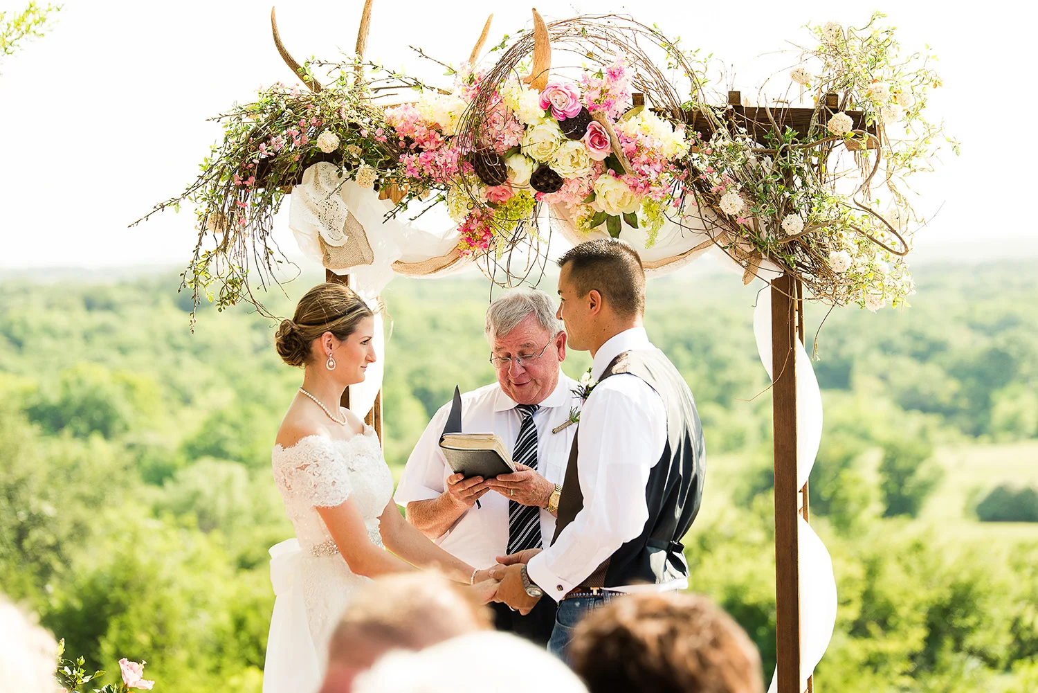 This summer ceremony was very challenging. We really lucked out with the large archway in the ceremony space because it provided a perfect shadow for my bride and groom. The ceremony was about 4 hours prior to sunset and light was almost directly overhead. Without the arch, there would have been strong light all over their skin, much like what you see on the groom's back. 