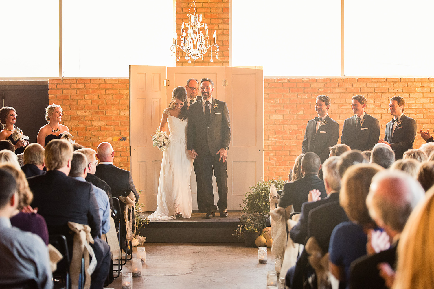This indoor fall wedding was right about sunset. Light was coming in from both sides and tons of harsh light behind the couple but the space itself was pretty dark. 