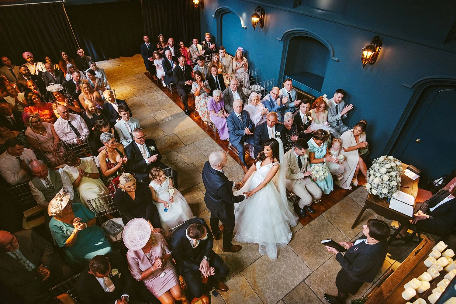 Lartington Hall wedding: wedding ceremony seen from above in a deep blue hall