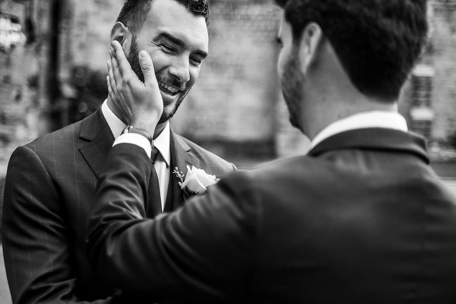 Durham Castle wedding: groom and best man sharing an emotional moment, black and white
