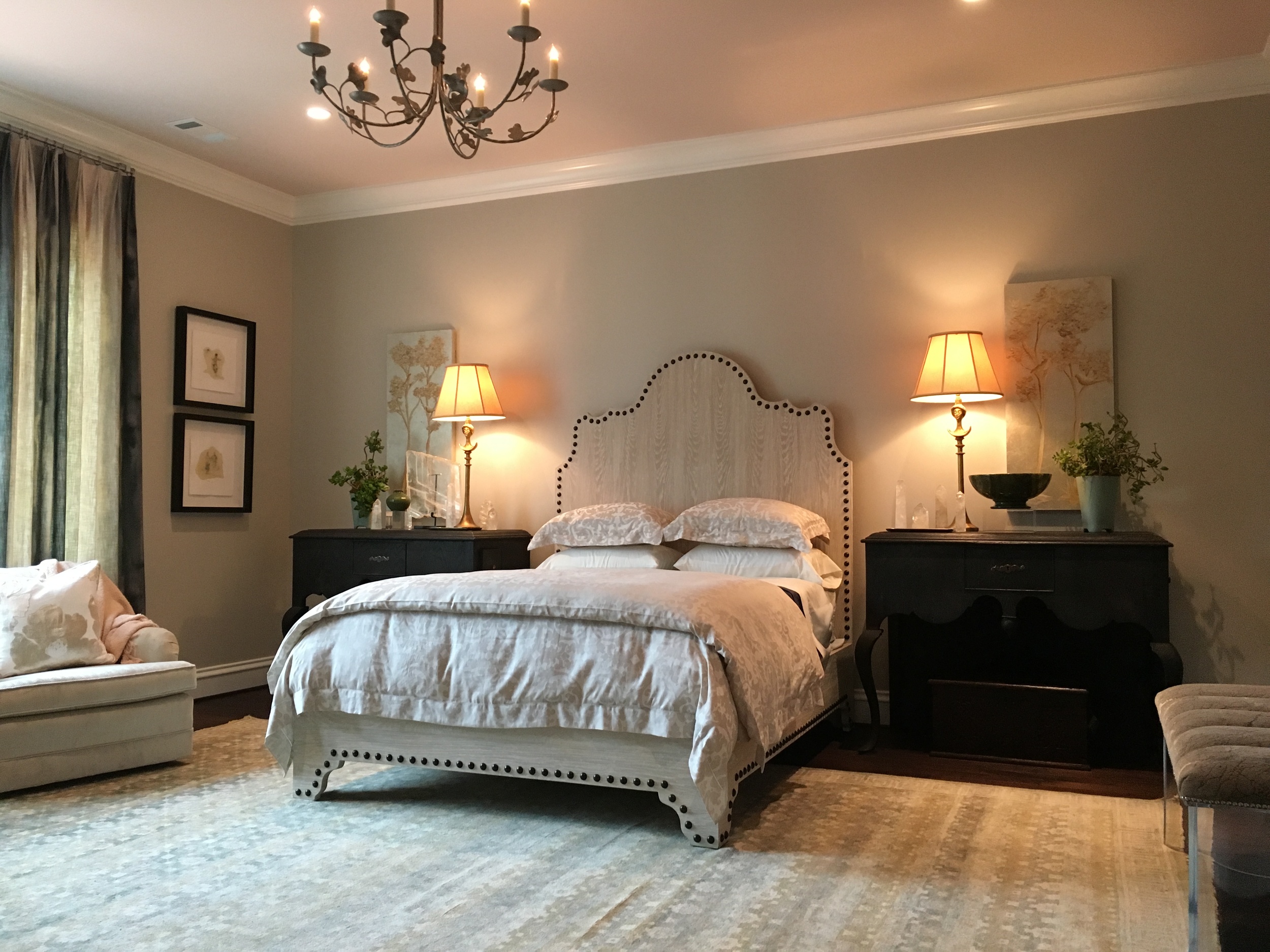In the Home for the Holidays showhouse, I selected a pale, blush pink for the ceiling color. The adjoining bathroom is also pale pink. There are soft blues in the rug, the artwork on either side of the bed and in the window treatments. I also used crystal quartz obelisks on each bedside table.