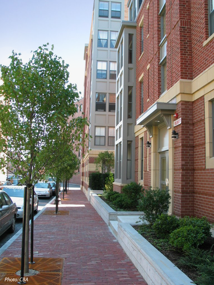 This 184-unit housing development was built on approximately two acres of vacant land. A goal for the project was to provide the City with significant open space. To achieve this, a 277 space, below grade parking garage was created with a park on its surface. Thus, the park at grade level is in reality a rooftop garden. This green space is a contemporary interpretation of the traditional South End Square. 