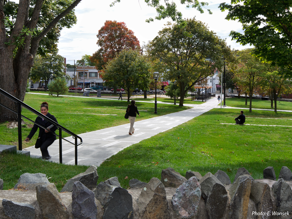 CBA's design for this neighborhood “commons” strikes a balance between refurbishing an historic greenspace and providing new activities. The site's defining diagonal walkways are joined by a meandering path connecting several new play features, selected to add a sculptural element to the site rather than the first impression being one of a playground. The many significant trees and historic stone wall around the park were protected. Paired fieldstone walls terrace the slope on both sides of the upper half of the main path, adding a dynamic element and providing more seating. Near the main entrance, a stepped wood and metal trellis shades groups of benches. The flattest area remains as open lawn for informal games. 