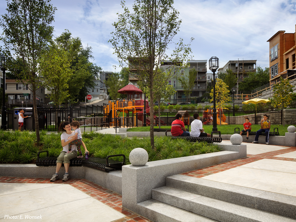 A new residential neighborhood is being created in the heart of Chelsea's former manufacturing area. One of the key components of the City's plan is this brand-new park on a significant corner. CBA's design combines a plaza area that draws visitors in, a water feature, stepped granite walls, a picnic area under a trellis, decorative brick and concrete paving, attractive fences, exciting play equipment, plantings, and open lawns to create a green respite with details and colors that reflect the industrial past.