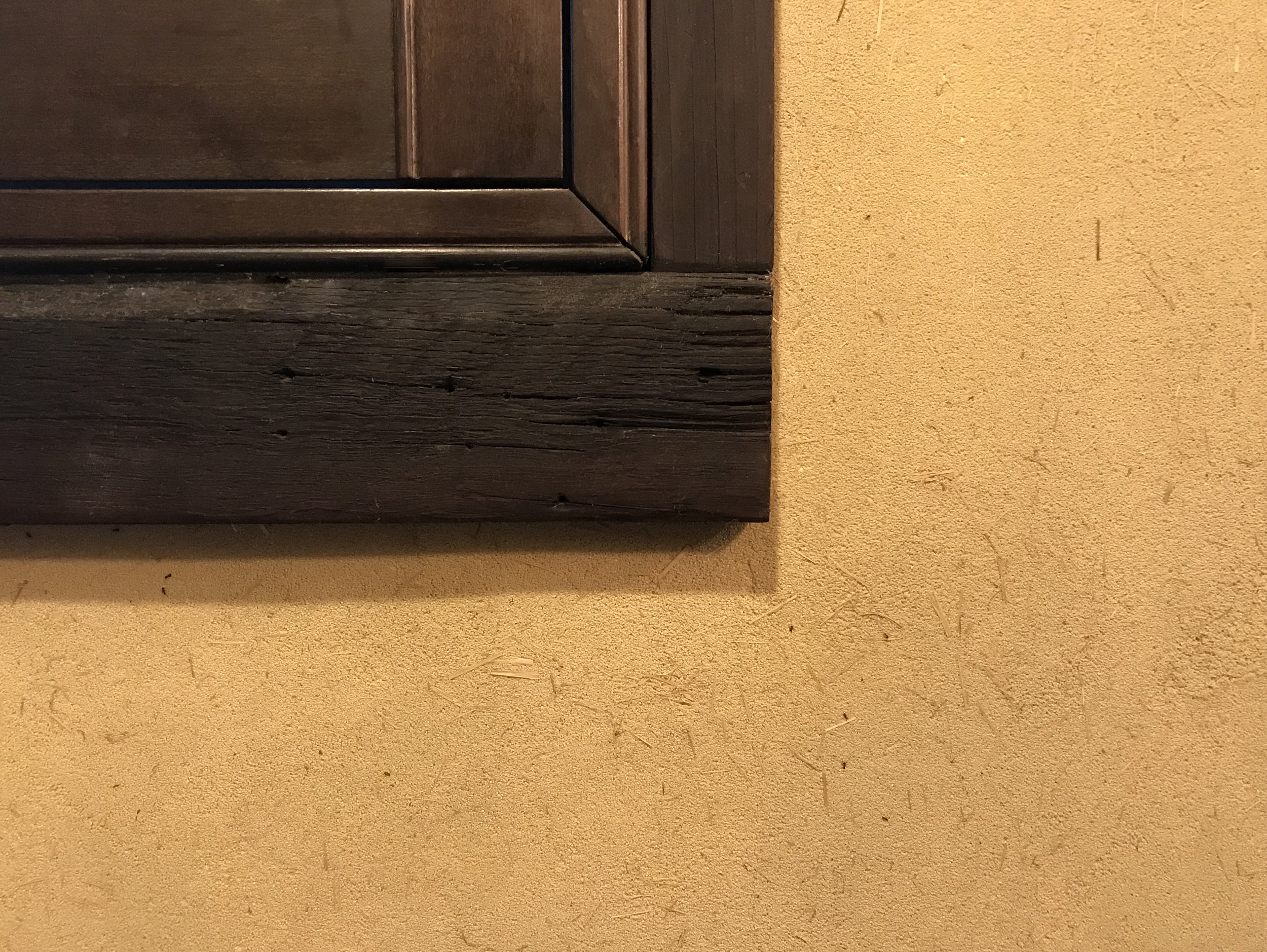Faux stone with straw, directly troweled onto wall.