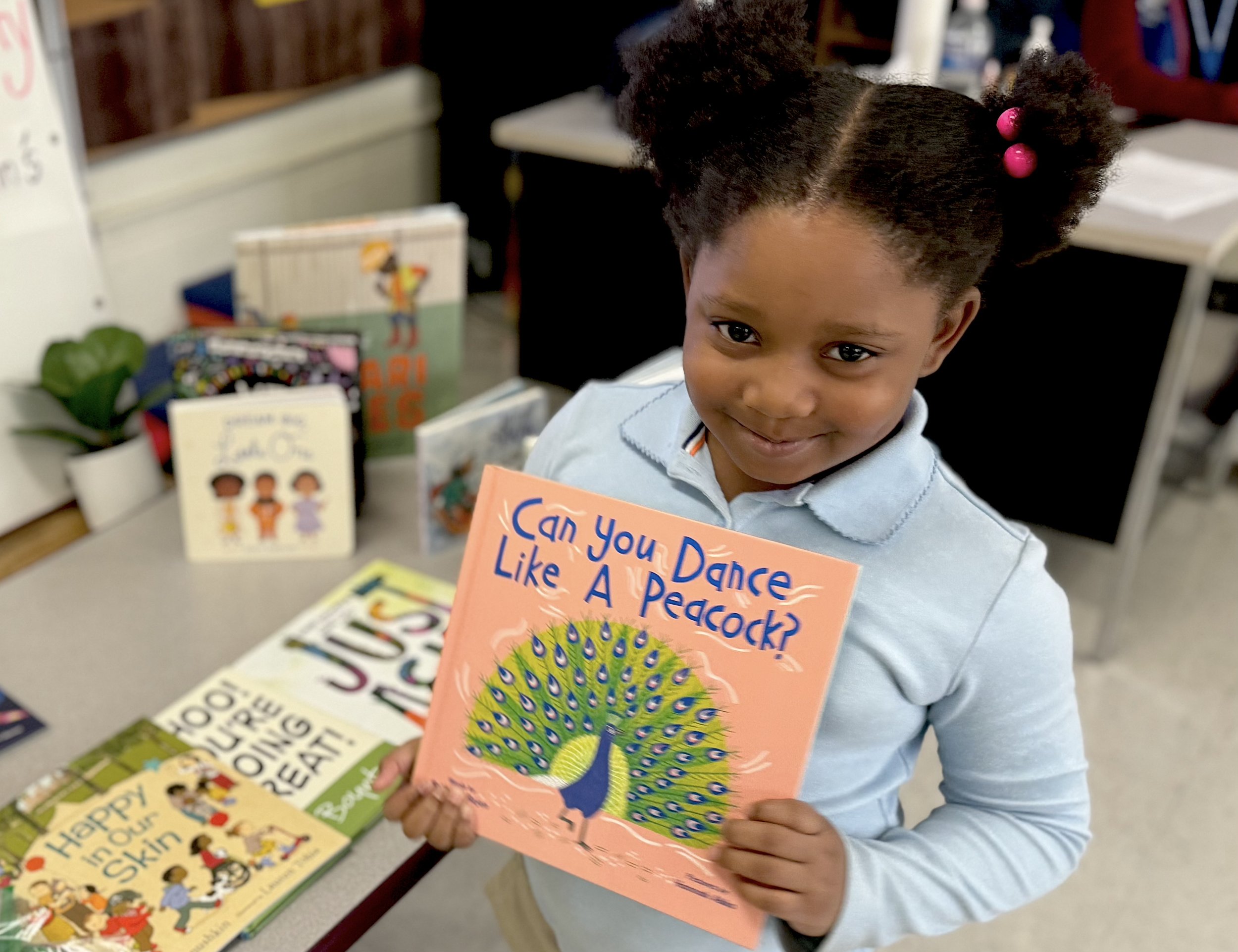  December 2023. Young lady shows off her favorite book during the FNN Early Birds Book Party at Friendship Chamberlain Elementary.  Click here  for more great book party photos.&nbsp; 