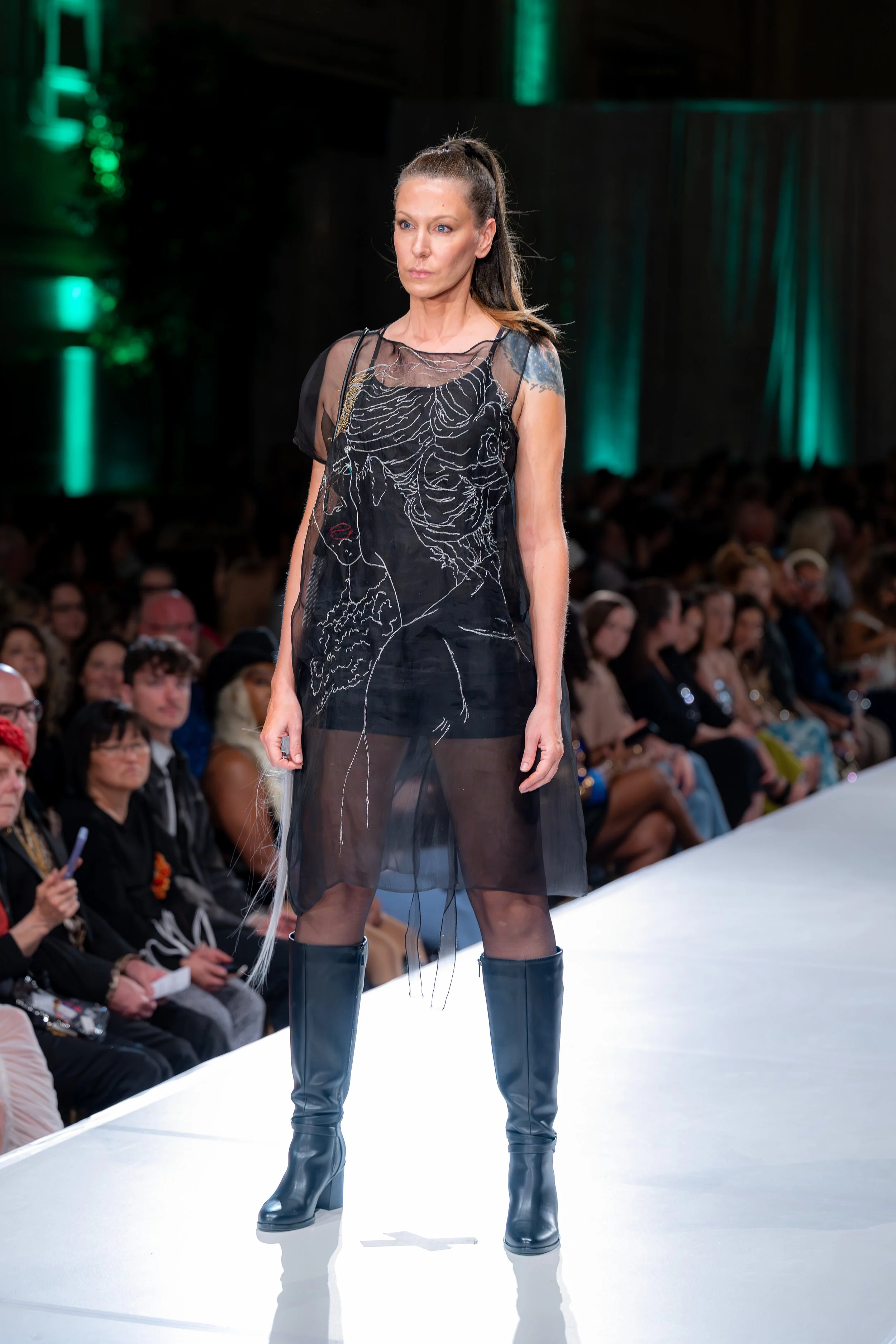 Black silk organza with a slit on the side to access your pockets, hand guided machine embroidery with original artwork. 

Kansas City Fashion Week F/W 2025