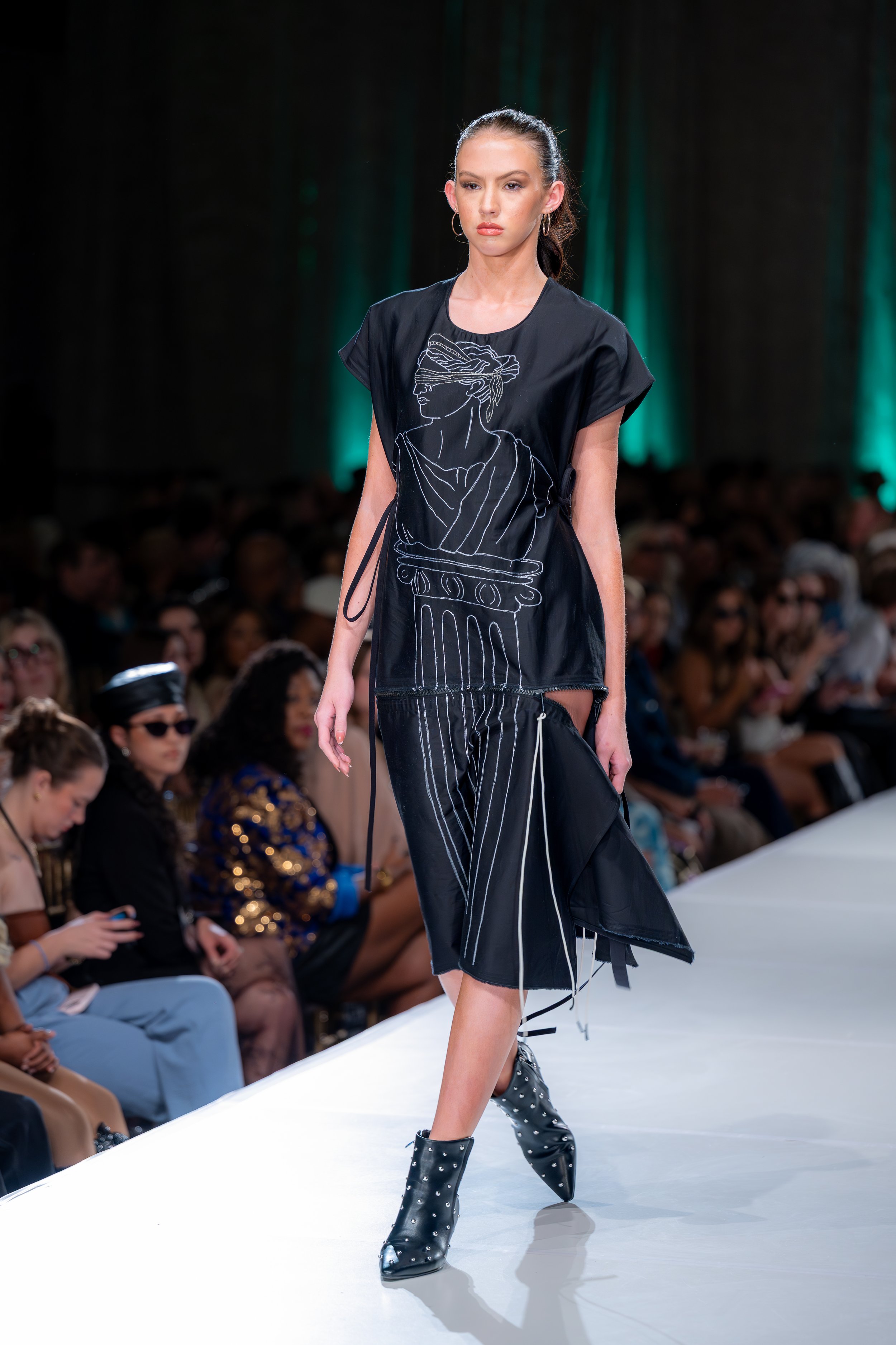 Black ponte knit deadstock dress with zipper detail and rubber dipped zipper pulls, two pockets, back closure, hand, guided machine embroidery with original artwork. 

Kansas City Fashion Week F/W 2025