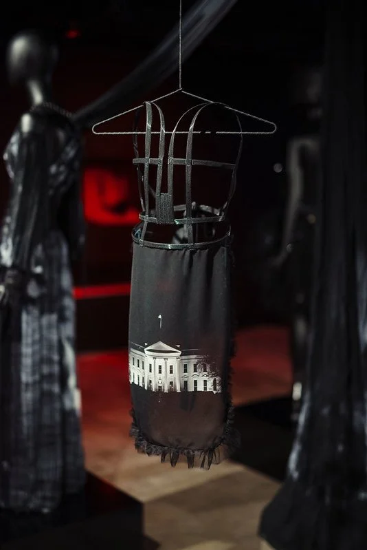 c3 (1), a suspended black corseted apron with a sublimation print of the White House