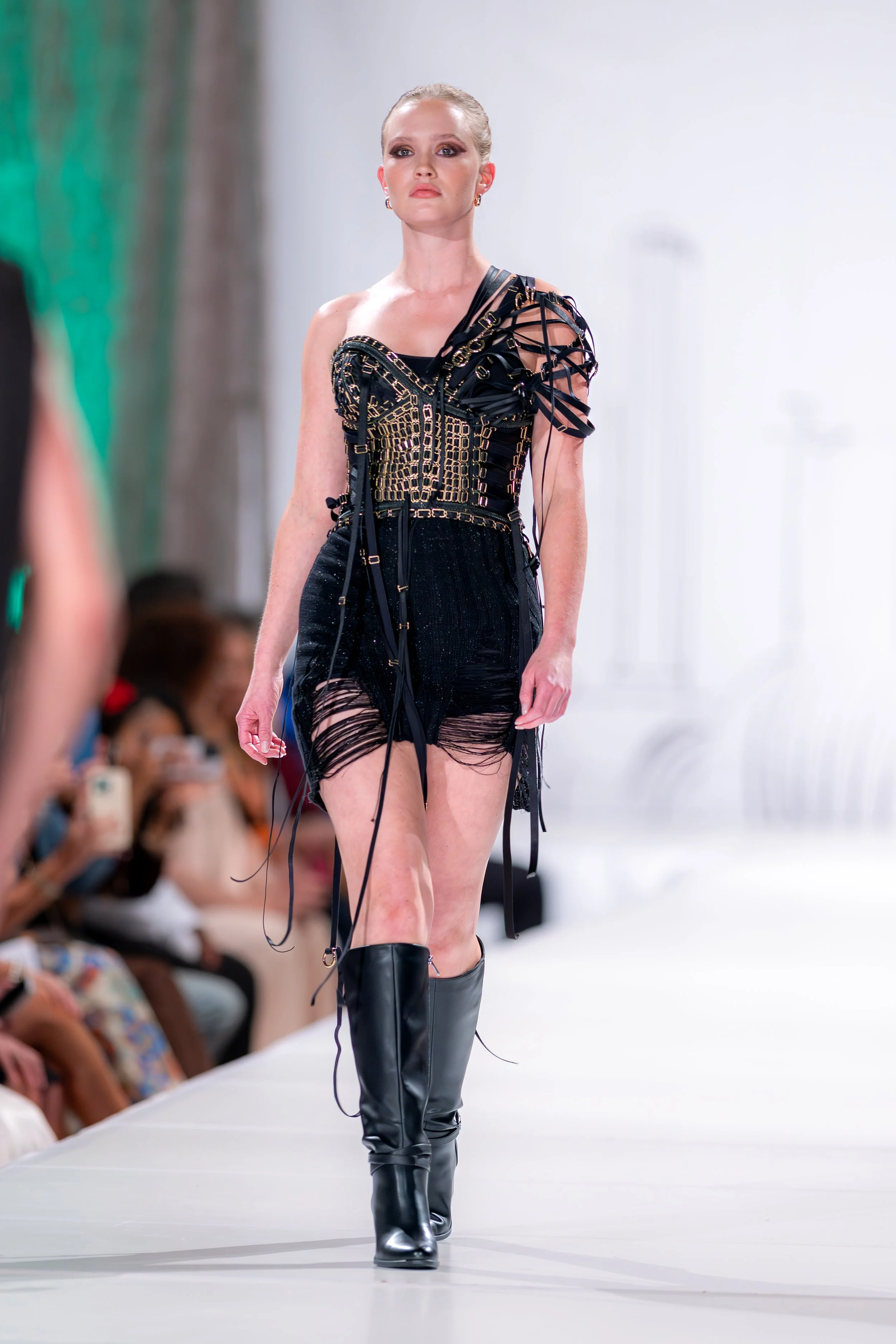 Handcrafted adjustable corset constructed entirely from reclaimed deadstock materials, featuring rubberized coated steel boning, laced satin bra elastic, gold-tone bra sliders, and a brass metal zipper. Black hand-knit deconstructed skirt in bamboo a