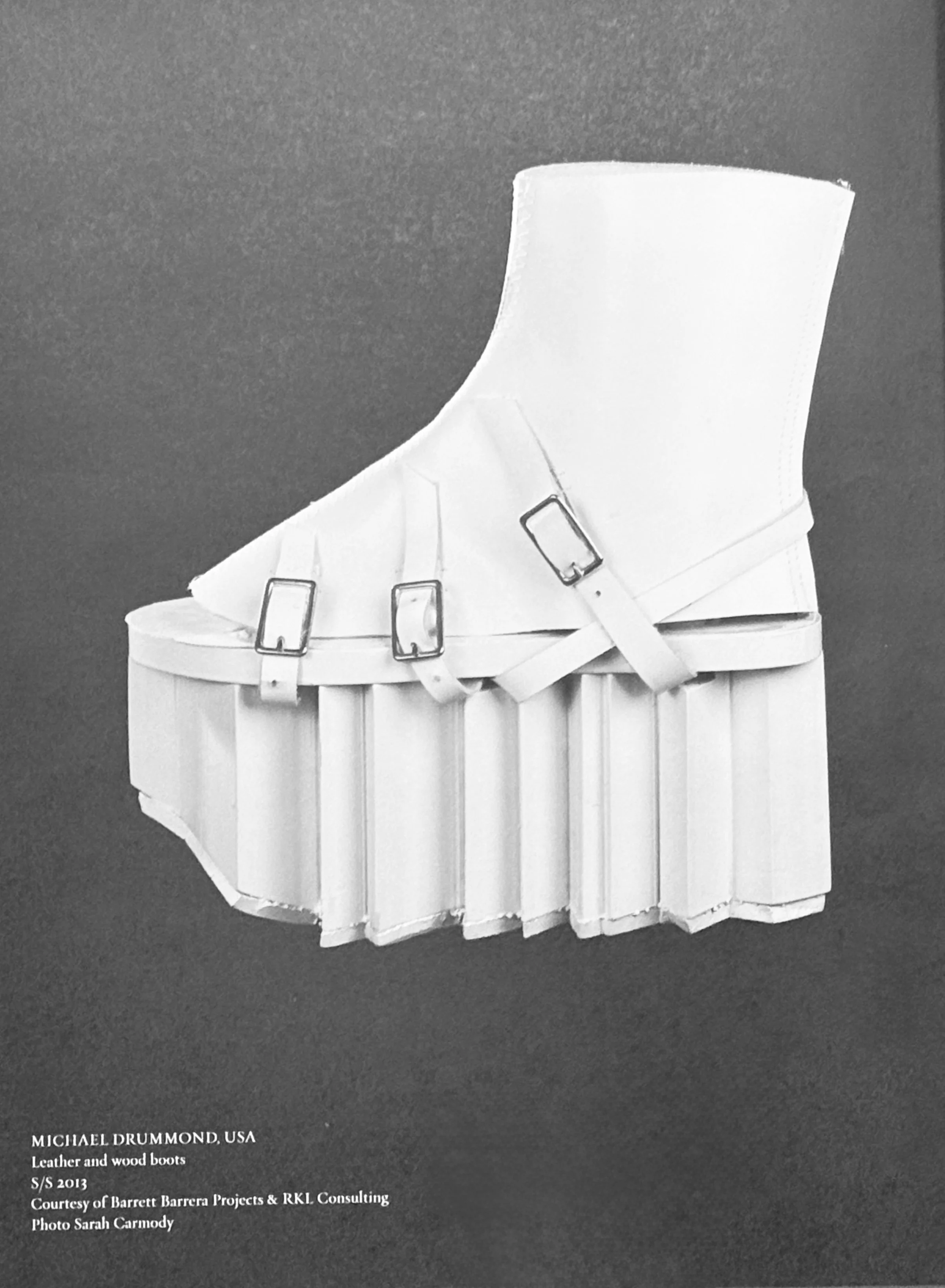 handmade white wood and leather boot with jagged edges and silver buckles shown in A Queen Within Adorned Archetypes 2013