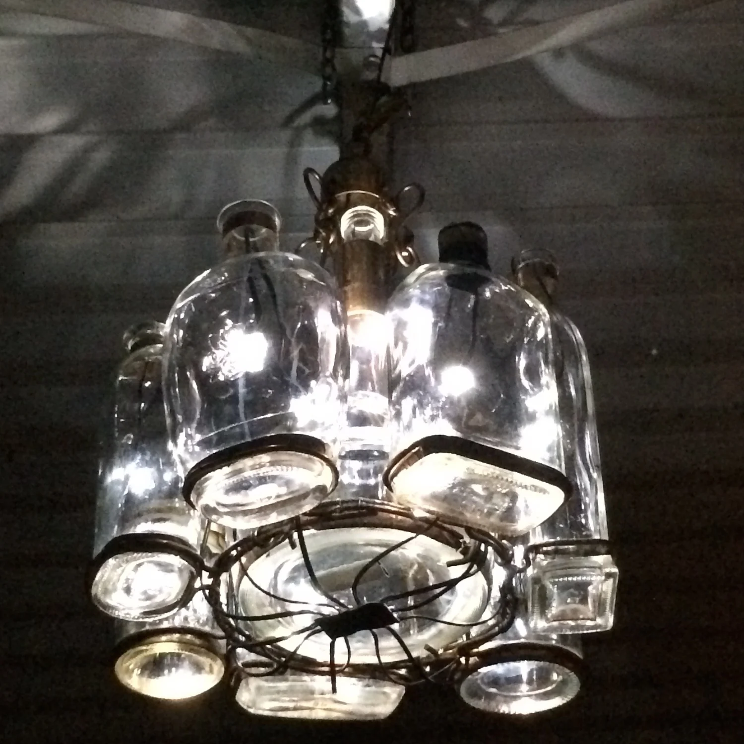 The Bluetooth-controlled, dimmable LED hand-built bourbon bottle chandelier at Halcyon