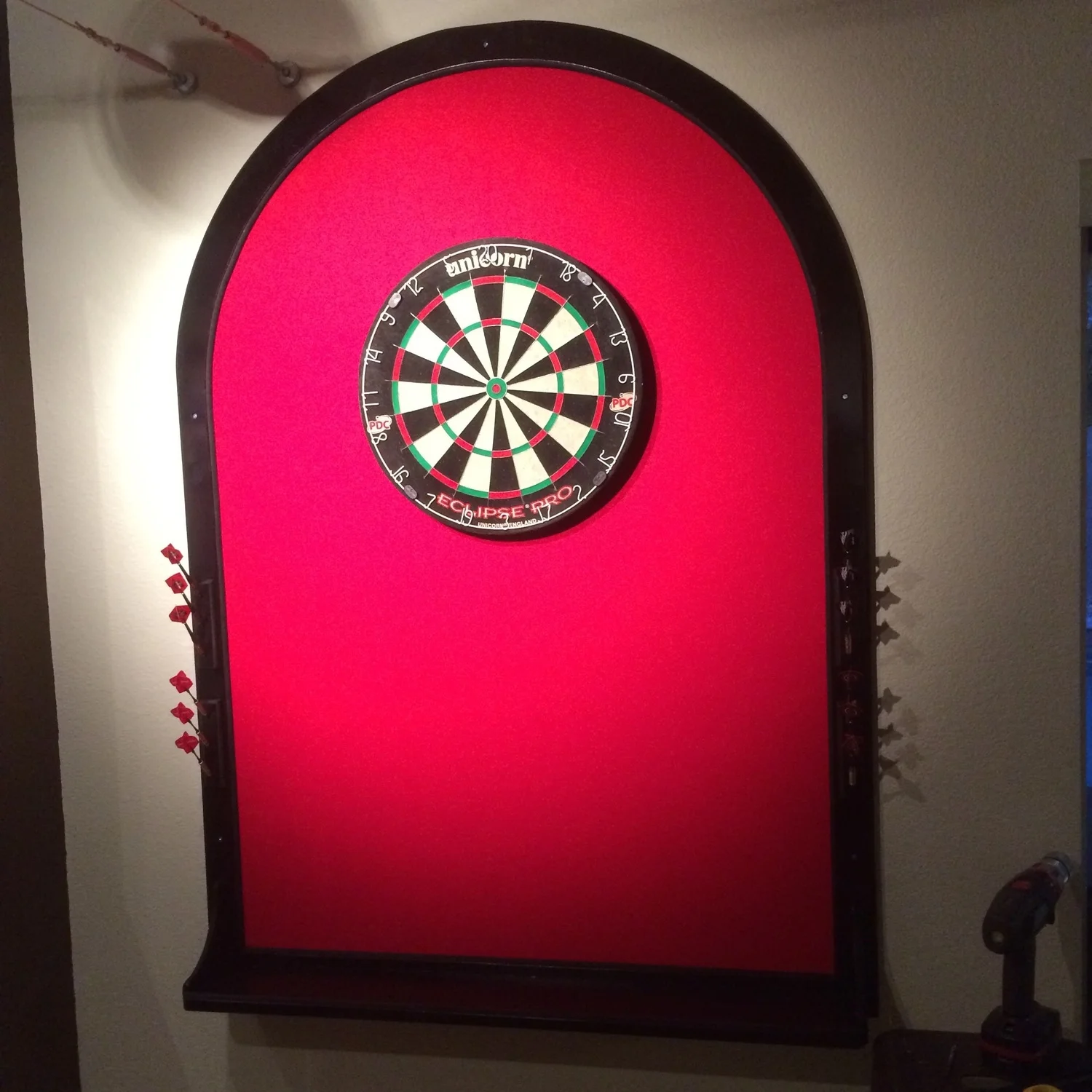 Finished dartboard backstop with red felt and black paint