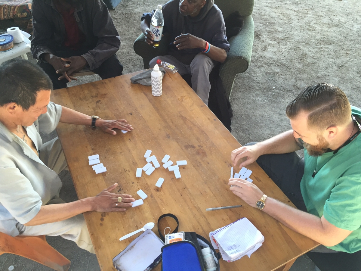 Andrew playing dominos with our people in Tent City