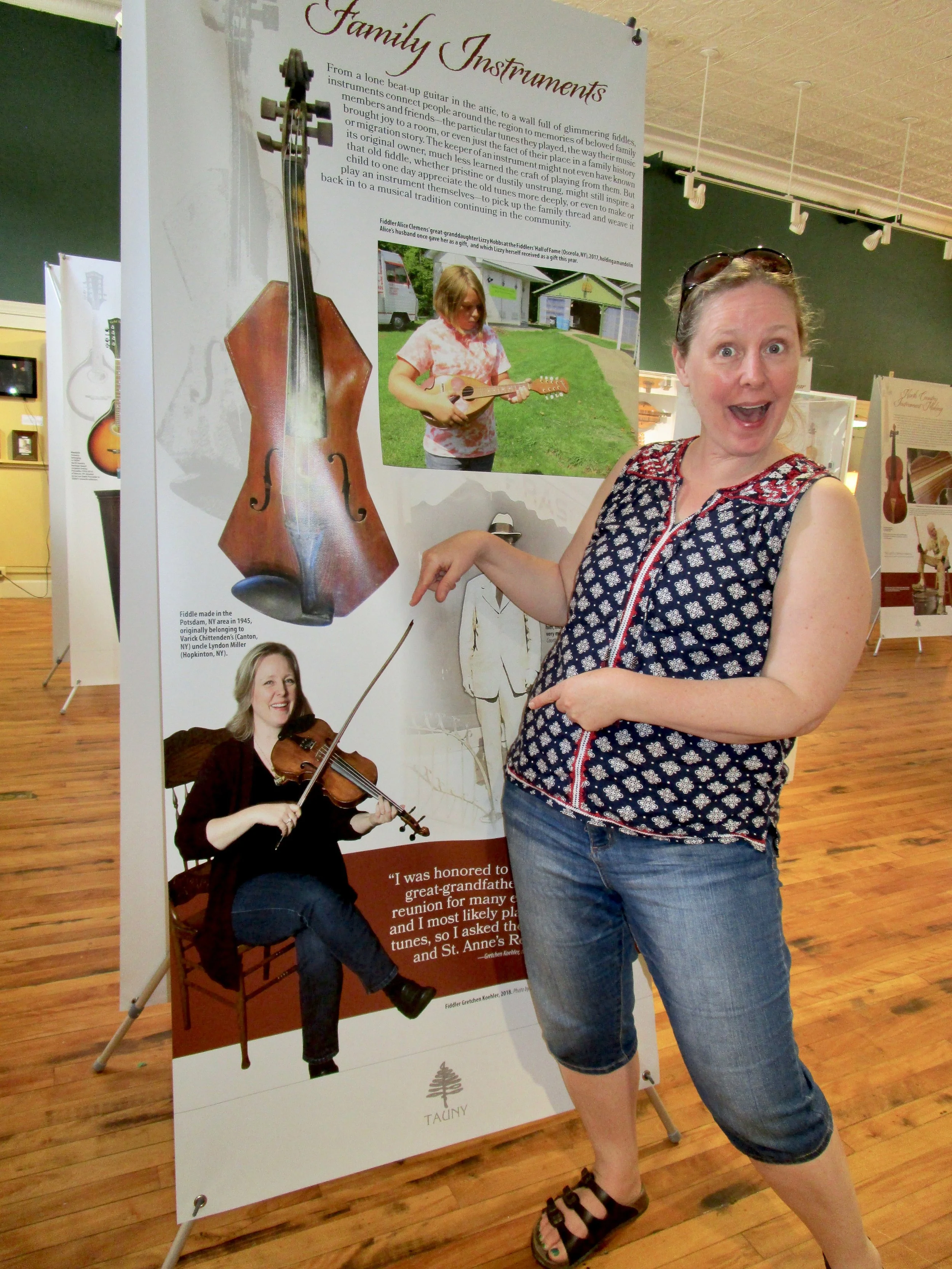 In addition to display cases filled with folk instruments, photos and stories dot the gallery, including a panel quoting fiddler Gretchen Koehler (Potsdam, NY)
