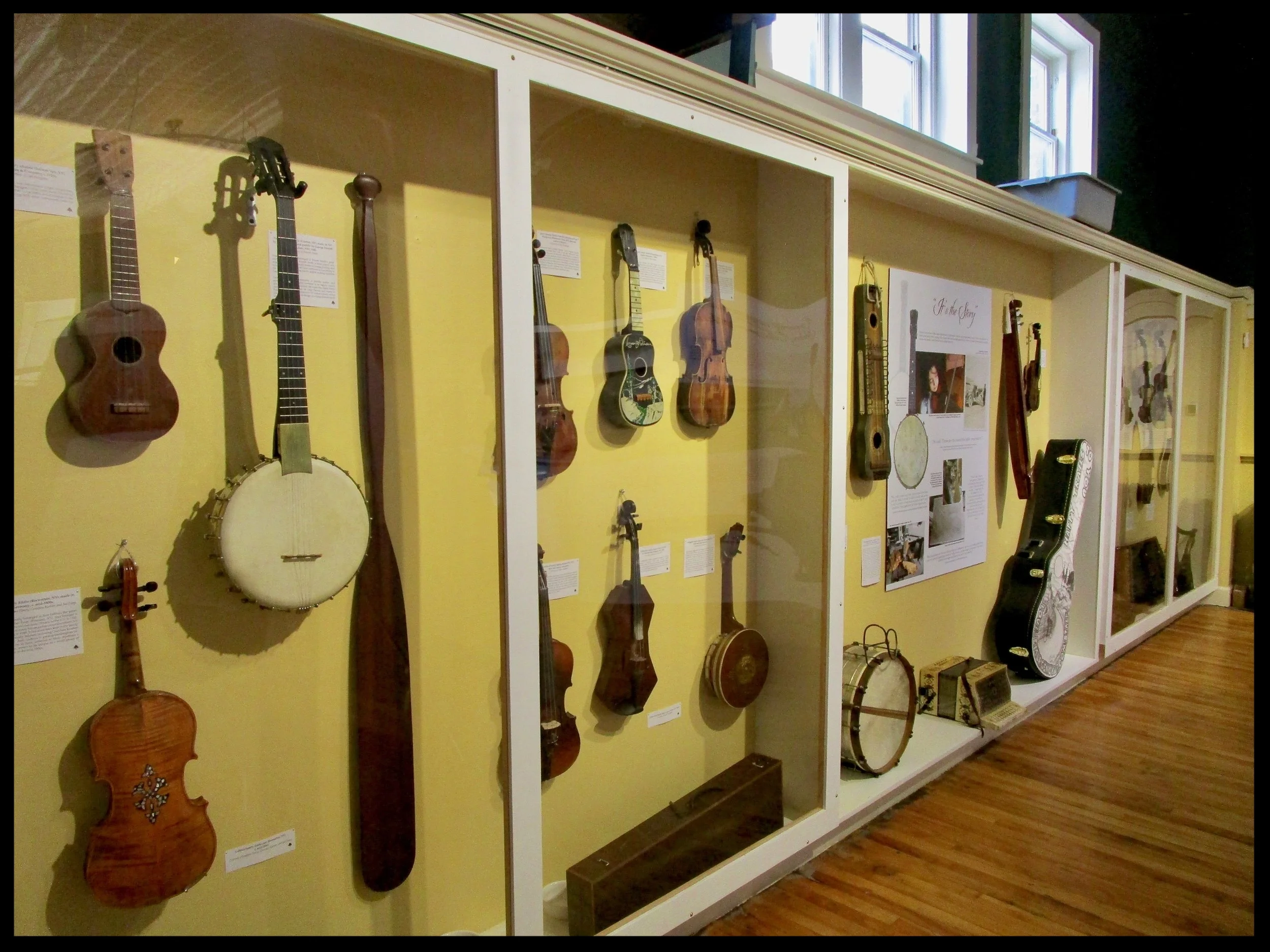 A multitude of musical instruments fill the walls of the TAUNY Gallery, Canton, NY.
