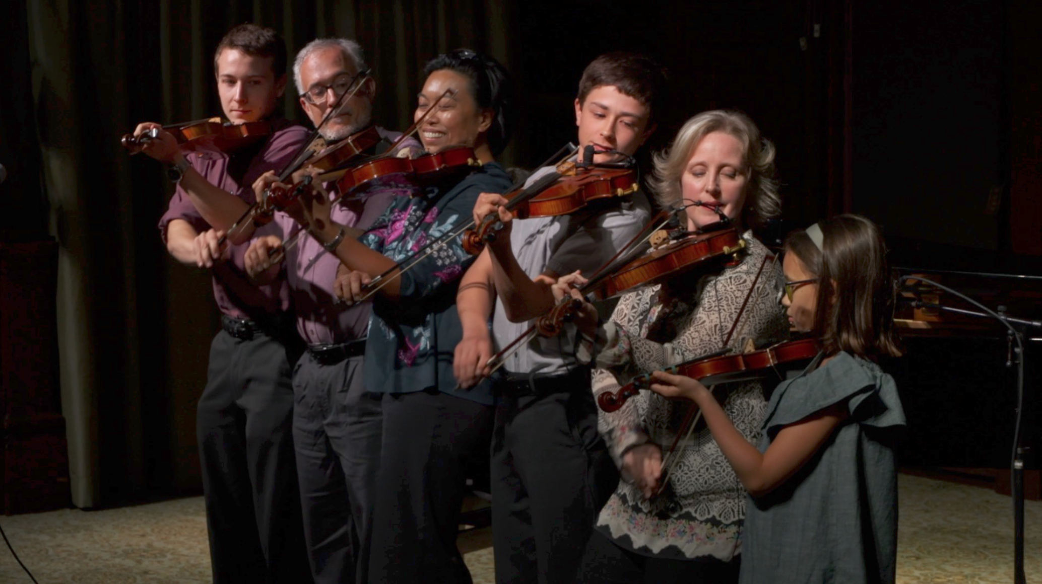 Members of the Koehler-Foisy & Kelly families performing the trick called “the 6 headed Fiddle Monster!”