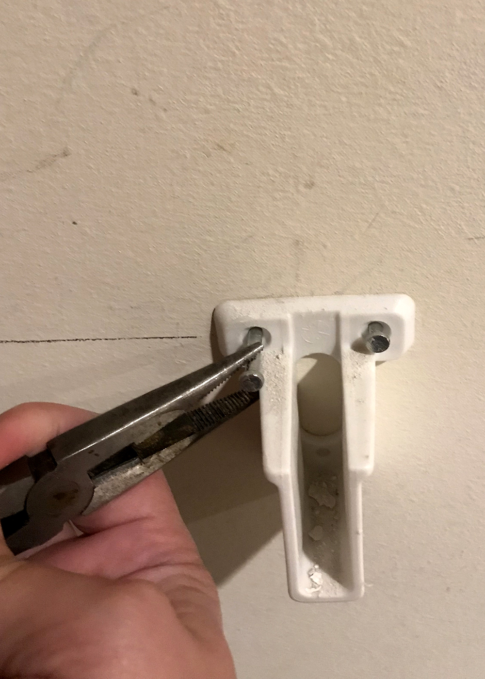 pliers work well in removing pins without damaging wall