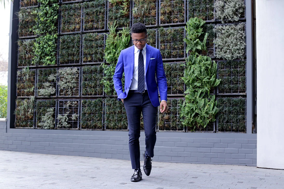It's officially the first day of spring! And I couldn't wait to get back to wearing bold and bright colors. As you guys may already know, spring is my favorite season of the year! Today I decided to bring out my bold blue suit jacket. I toned it down a bit by omitting the matching trousers. The jacket pairs perfectly well with the navy trousers and the light blue shirt. I kept it sharp and neat with a navy striped tie, and opted for a green gingham pocket square for a little pizzazz. Completed the look with a black pair of monks and navy polka dot socks. Hope you guys enjoy. Happy Spring! Outfit details: Suit Jacket by PAUL SMITH Trousers by RIVERISLAND Tie by BOWS N TIES Pocketsquare by GALLANTBEAU Shoes by PRADA Socks by BEDFORD & BROOME