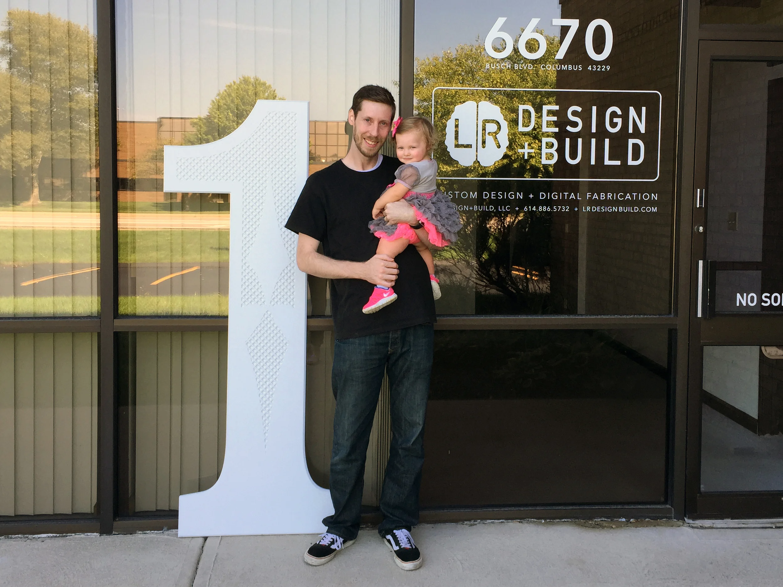 Christopher with daughter Kailaa celebrating her and LR Design+Build's first birthdays